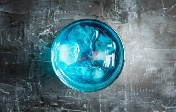 istock Blue old fashioned cocktail with cherry on the rustic background 1216205093