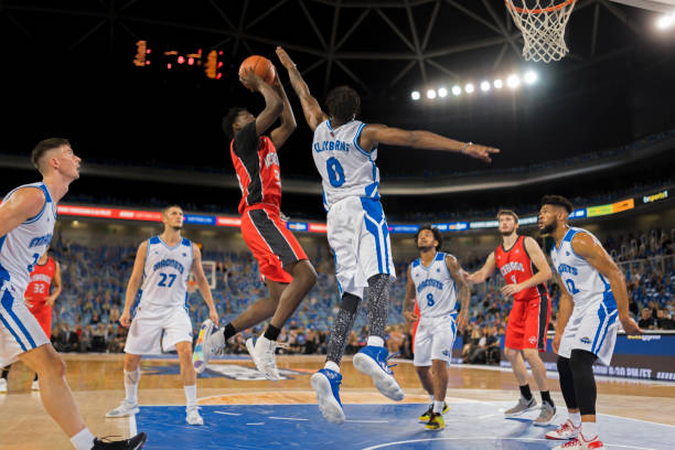 istock Basketball players playing on court 1216206482