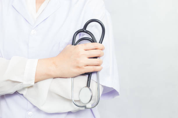 istock An attractive young female doctor in white coat holds a folded stethoscope. 1216206636