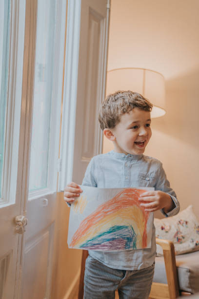 istock Young Boy showing his drawing on home during the Covid-19 crisis 1216207475