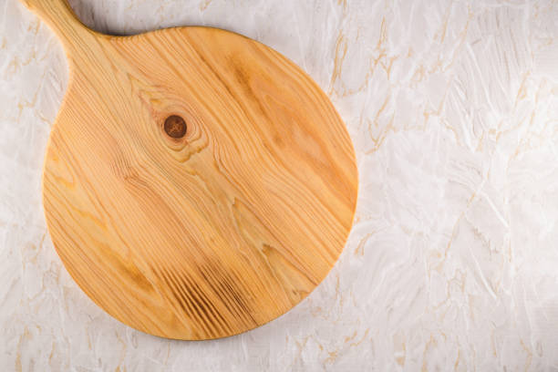istock Wooden cutting board on a gray marble background 1216207770