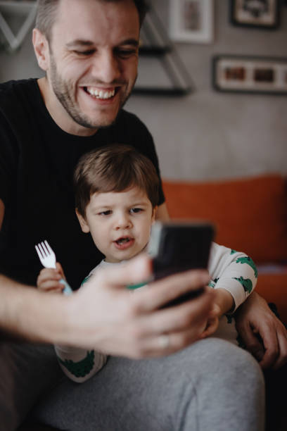 istock Father and son connect with family during quarantine 1216208439