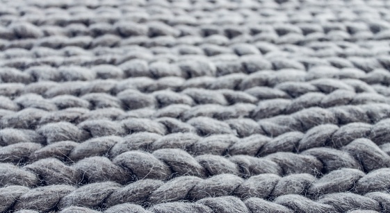 knitted texture. gray and blue color, the result of knitting by hand