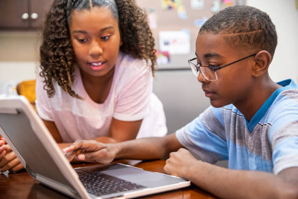 istock Young Black boy and girl homeschooling 1216210837