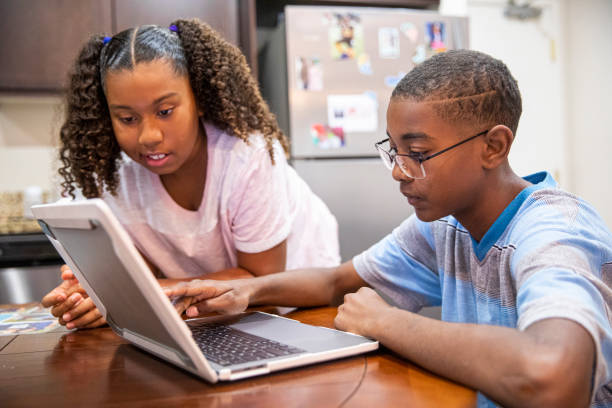 istock Young Black boy and girl homeschooling 1216210896
