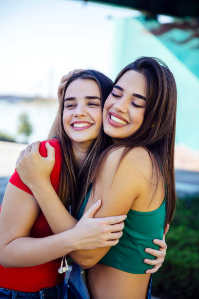 istock Two best female friends embracing together 1216212352