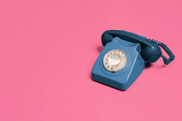 istock Blue vintage rotary phone on a pink background 1216212441