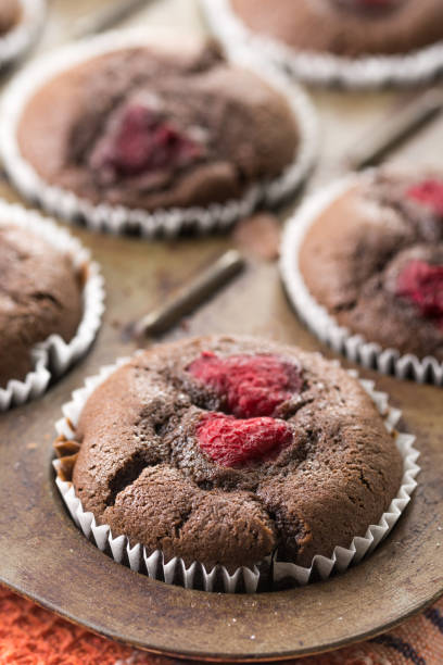 istock Selective focus on baked chocolate cup cake with raspberries 1216214027