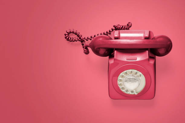 istock Red rotary phone on a red background 1216214191