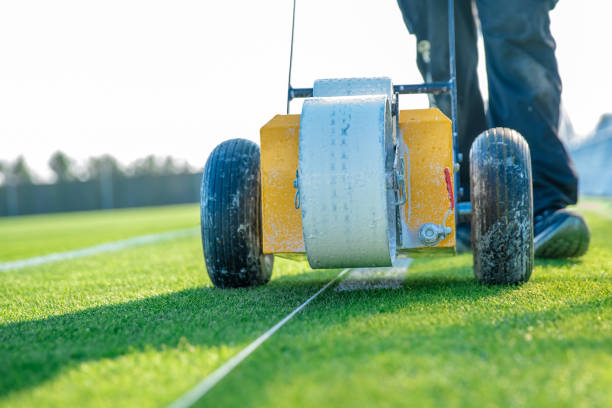 istock drawn white lines on the football field with white paint on the grass using a special machine before a game 1216214325