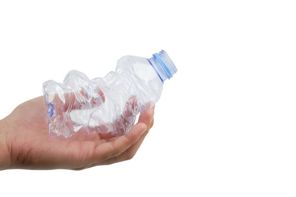 istock Garbage plastic bottles in the hands isolated on white background. 1216214845