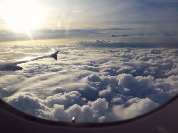 istock Sunrise And Clouds Outside Airplane Window 1216214851