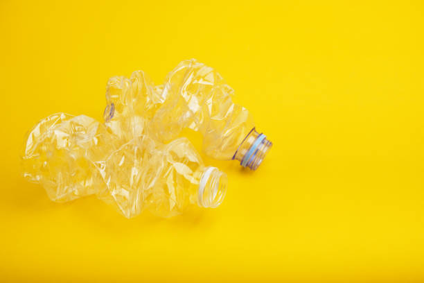 istock Used plastic bottles without cap isolated on yellow background. 1216214876