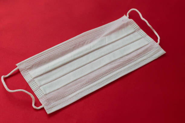 istock medical mask on a red background. protection against viruses 1216215590