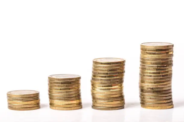 Stock steps of metal coins isolated on white background.