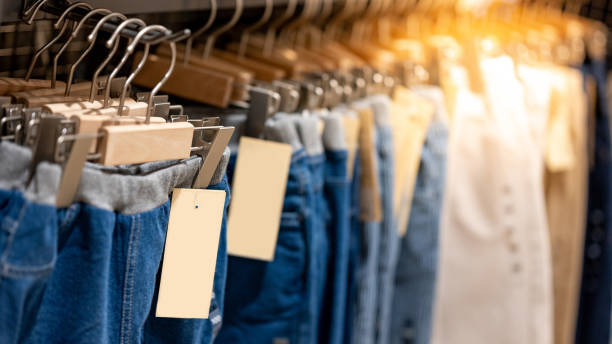 istock Jeans hanging on rack in clothes shop 1216216191