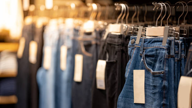 istock Jeans hanging on rack in clothes shop 1216216211
