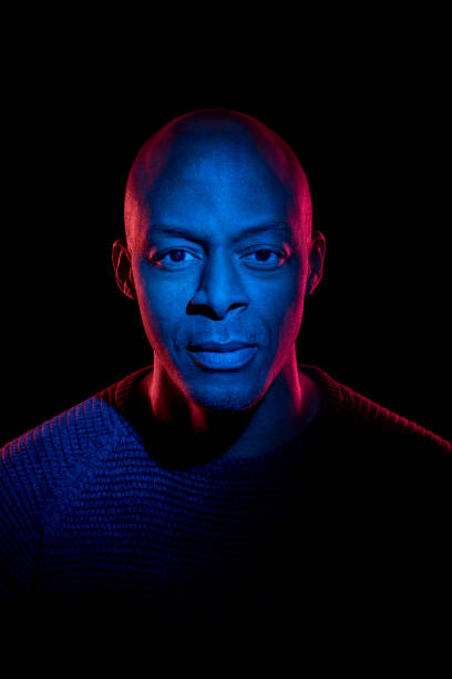 istock Black man with blue and red light looking at the camera 1216216276