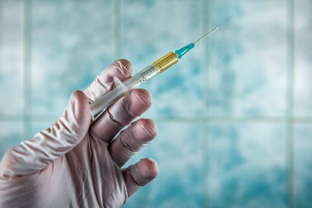 syringe with coronavirus vaccine syringe with new SARS-CoV-2 coronavirus vaccine in human hands crista ampullaris photos stock pictures, royalty-free photos & images