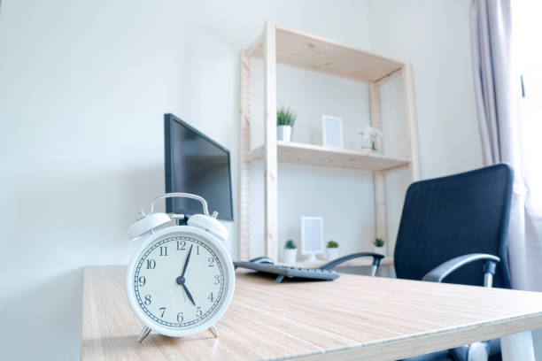 istock Clock on work desk in studio Time of businessman. Work from home 1216216637