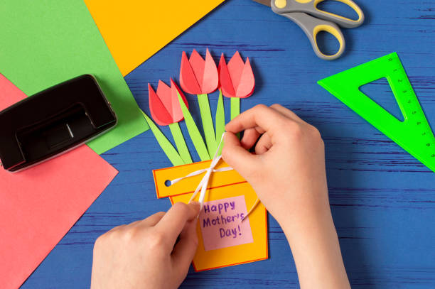 Child makes card for Mother's Day. Step 12 stock photo