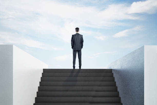istock Businessman standing on top ladder 1216218307