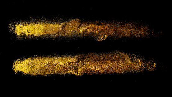 Two golden strips of acrylic paint on a black paper background. Web banner for text and design.