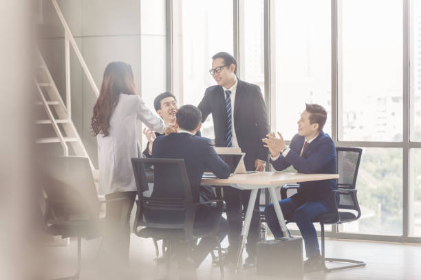 istock business team Asian congratulating Colleague 1216219081
