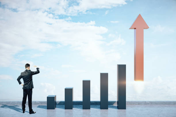istock Businessman looking on stock chart and red arrow in form rocket 1216219318