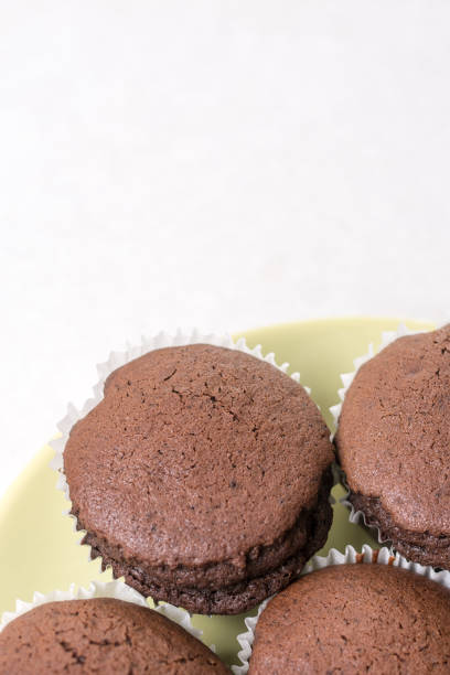 istock Flat lay above chocolate cup cakes on the white marble background with copy space 1216219732