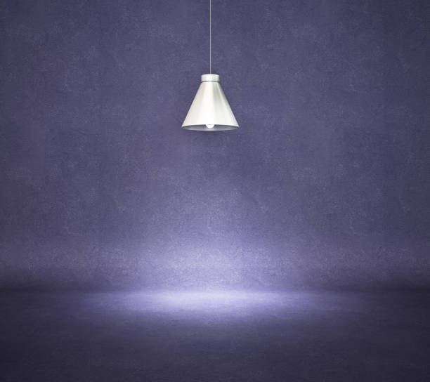 istock Vintage style hanged ceiling lamp with dark blue concrete wall 1216219834