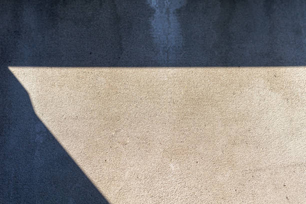 istock Old concrete wall, natural texture. Light background. The shadows. 1216221111