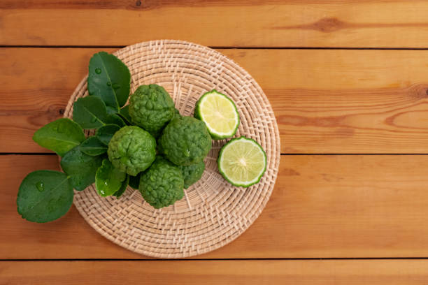 Fresh bergamot from nature Resting on a wooden chopping board To be used as a cook and nourish the skin. Bergamot is a plant in the genus Citrus. Originated in Laos, Indonesia, Malaysia and Thailand in Southeast Asia. Kaffir lime leaves and kaffir lime are commonly used as part of many food ingredients. nourish stock pictures, royalty-free photos & images