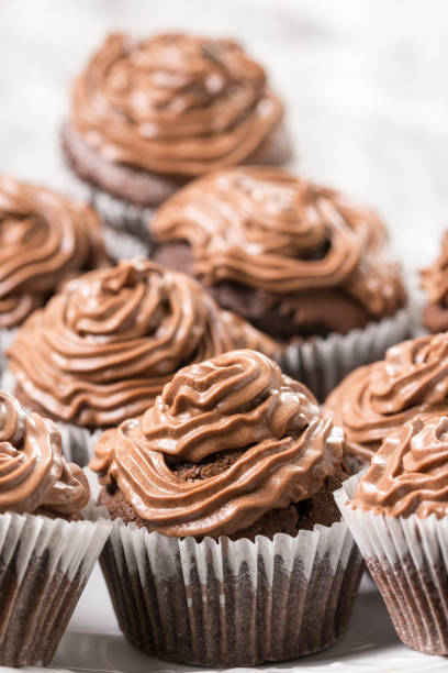 istock Plate full with chocolate cup cakes and with ganache chocolate cream 1216222335