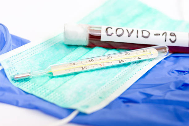 istock Thermometer and test tube with blood 1216222500
