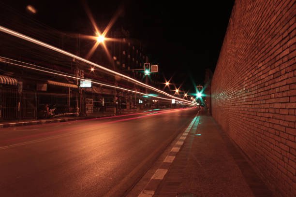 istock masonry brick wall at night street with car speed light 1216223609