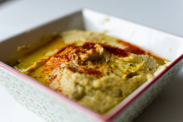 Arab food, chickpea hummus with olive oil and paprika on a white plate