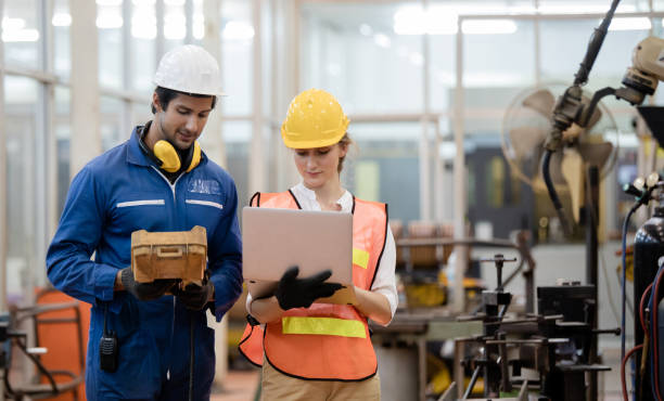 istock Engineer and worker control and check robot working in factory. The worker is controlling the robot to work in the factory. 1216224088