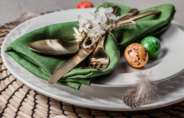 istock Easter table setting. Empty plates with green linen napkin and golden cutlery on concrete background. Top view. Flat lay. Copy space. 1216224762