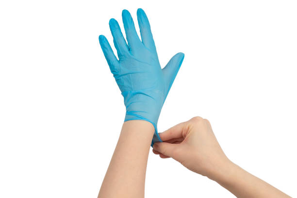istock Woman puts on blue rubber gloves. 1216224859