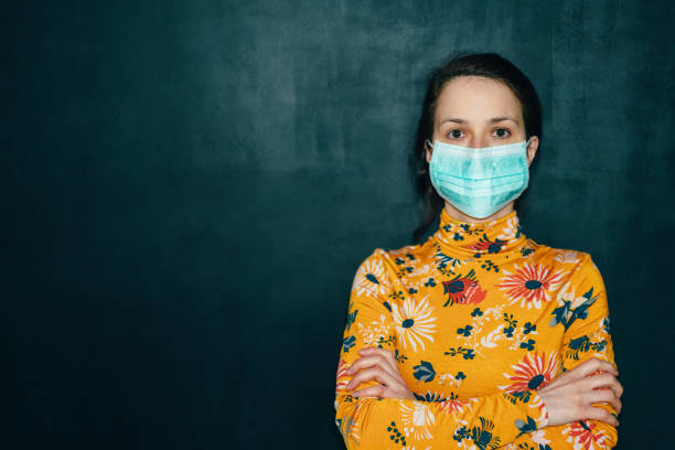 Woman wearing protective face mask during COVID-19 pandemic Woman wearing protective face mask for safety  during COVID-19 world health organization photos stock pictures, royalty-free photos & images