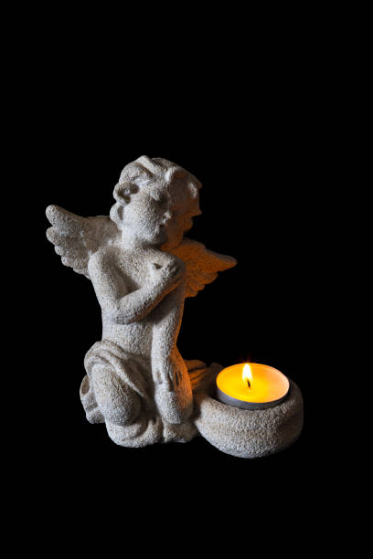 istock Small stone angel candle holder with a candle lit 1216227160