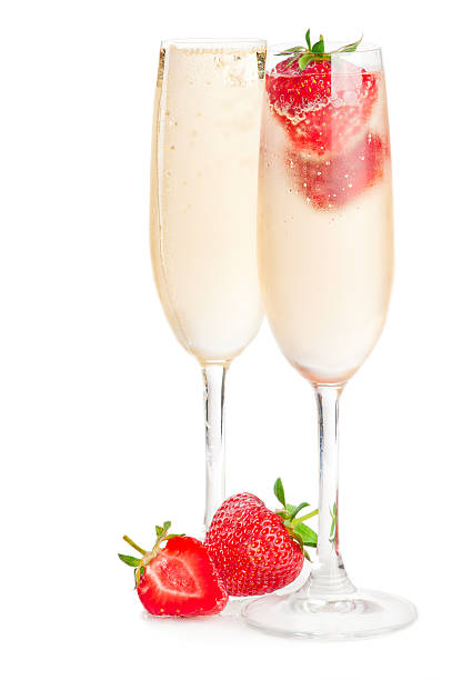 A single glass of Champagne with a strawberry.