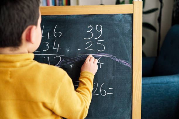 istock Education at home. 6-7 years old child learning mathematics at home. 1216228902