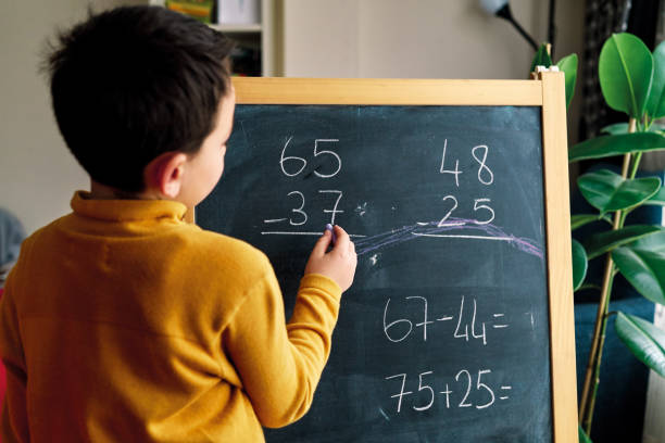 istock Education at home. 6-7 years old child learning mathematics at home. 1216229106
