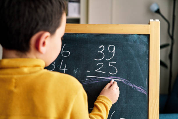 istock Education at home. 6-7 years old child learning mathematics at home. 1216229225