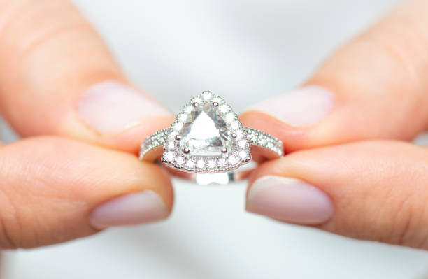 istock Woman Holding a Diamond Ring 1216229805