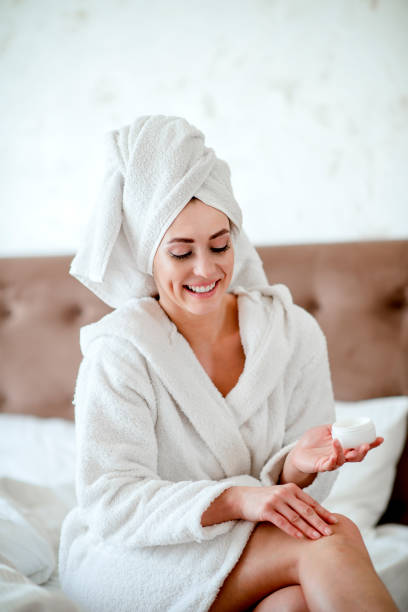 istock Woman Applying Moisturizer To Her Legs 1216230408