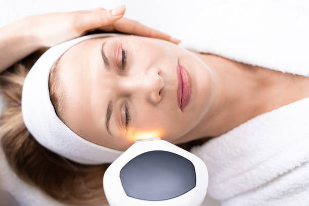 istock Beautician performing photorejuvenation procedure 1216230943