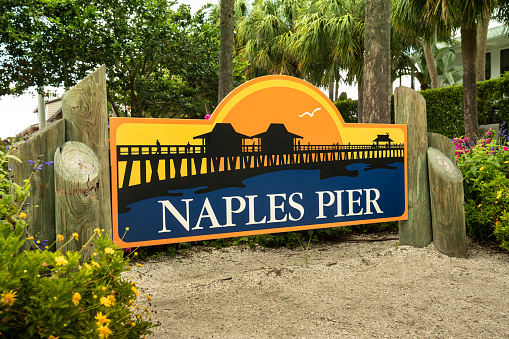 Naples, Florida - June 14, 2019:  Naples Pier road marker by the beach in Naples Florida USA